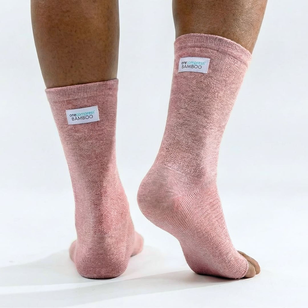 Pink bamboo compression foot sleeves worn on both feet