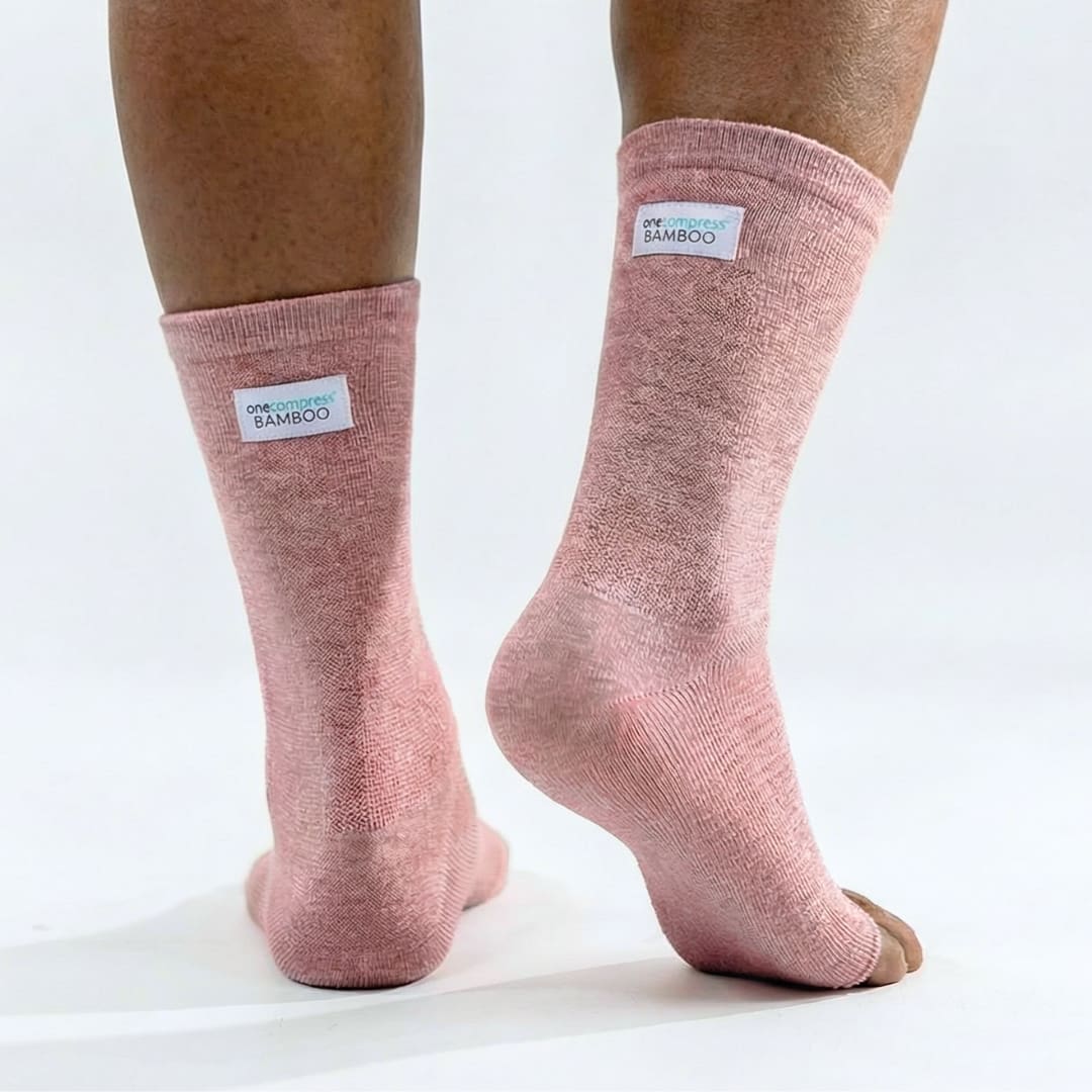 Pink bamboo compression foot sleeves worn on both feet