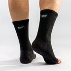 Black bamboo compression foot sleeves worn on both feet