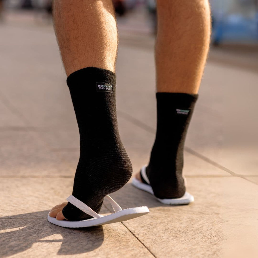 Black bamboo compression foot sleeves worn with casual shoes