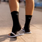 Black bamboo compression foot sleeves worn with casual shoes