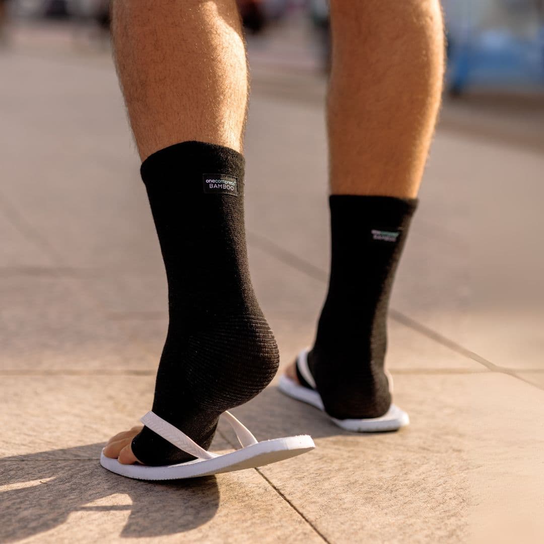 Black bamboo compression foot sleeves worn with casual shoes