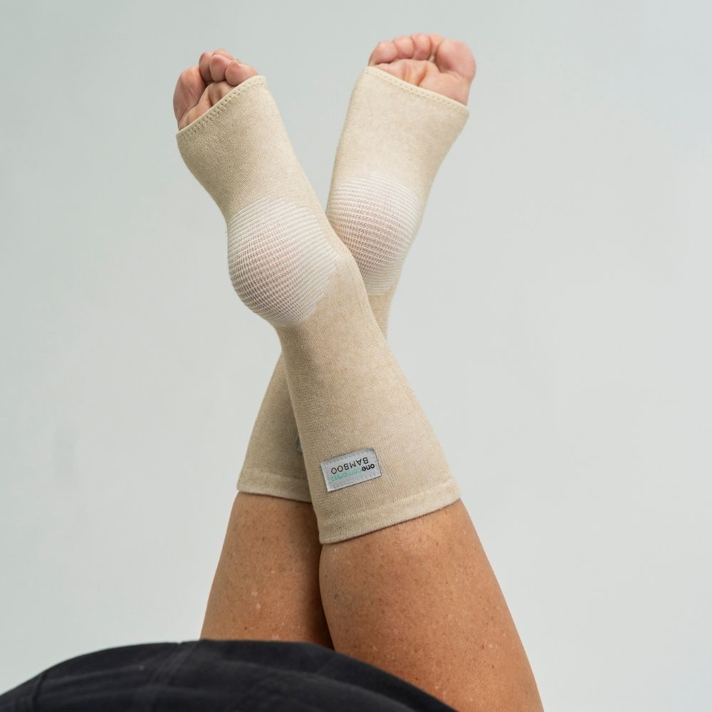 1. Cream bamboo compression foot sleeves showing flexible open-toe design
