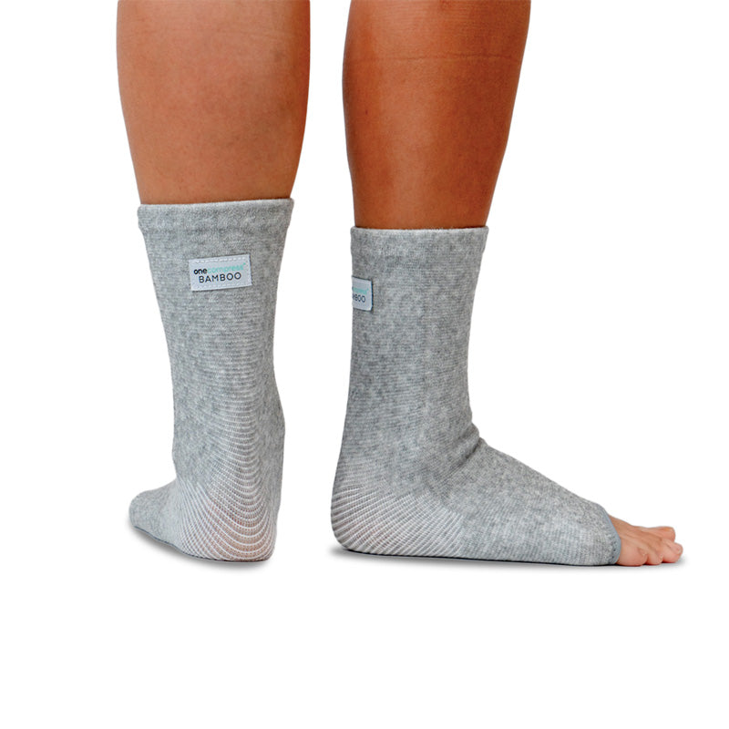 Pair of gray bamboo compression foot sleeves worn on both feet