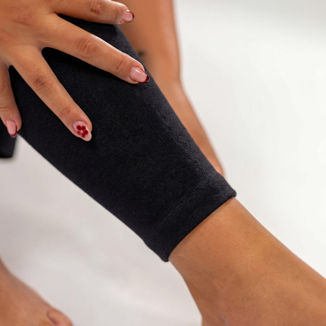 Close-up of black compression leg sleeve around the thigh
