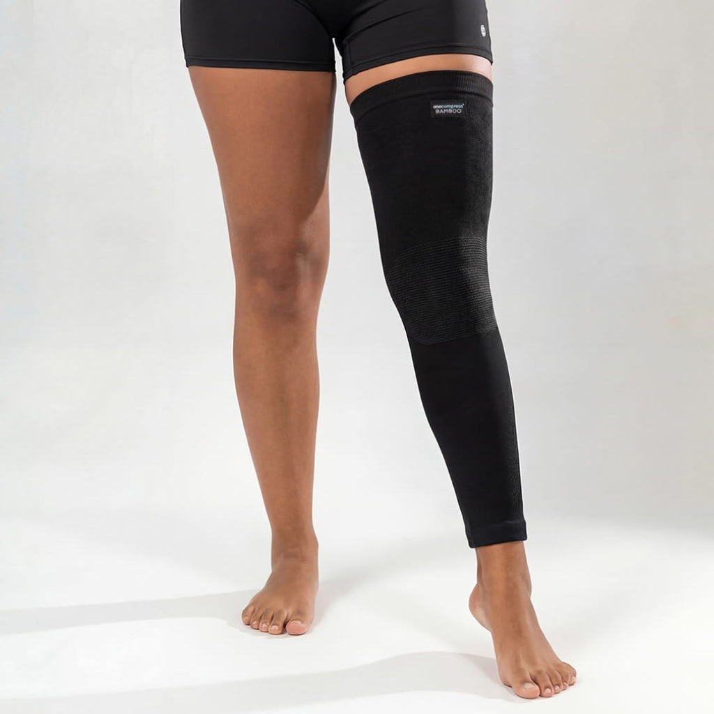 Black bamboo compression leg sleeve worn from thigh to ankle