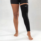 Black bamboo compression leg sleeve worn from thigh to ankle