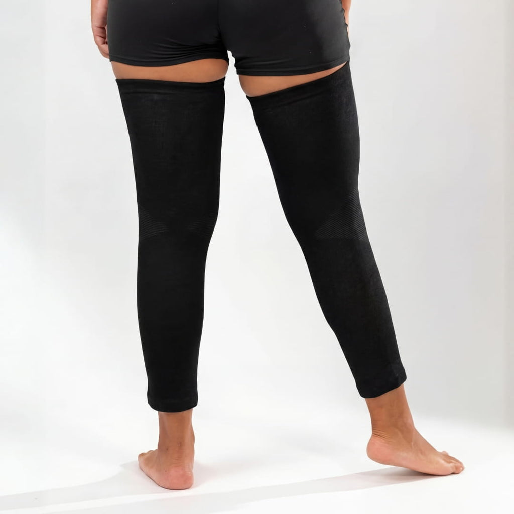Black full-leg compression sleeves worn on both legs
