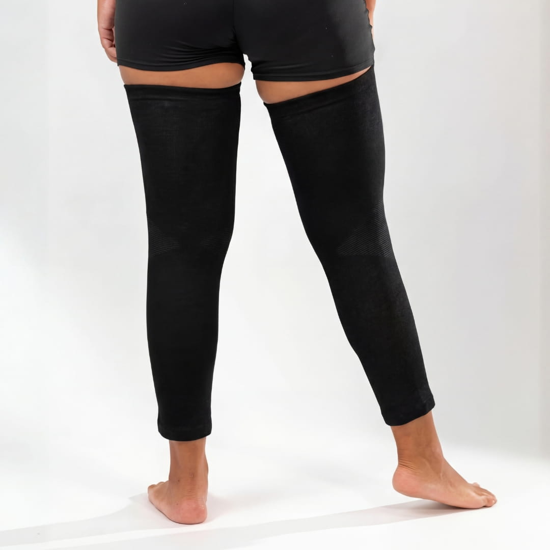 Black full-leg compression sleeves worn on both legs