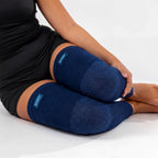 Rolled navy bamboo compression leg sleeves showing flexible fabric