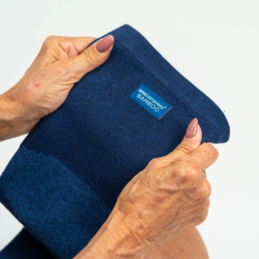 1. Close-up of navy bamboo compression leg sleeve stretch and fabric