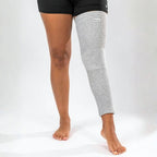 Gray bamboo compression leg sleeve worn from thigh to ankle