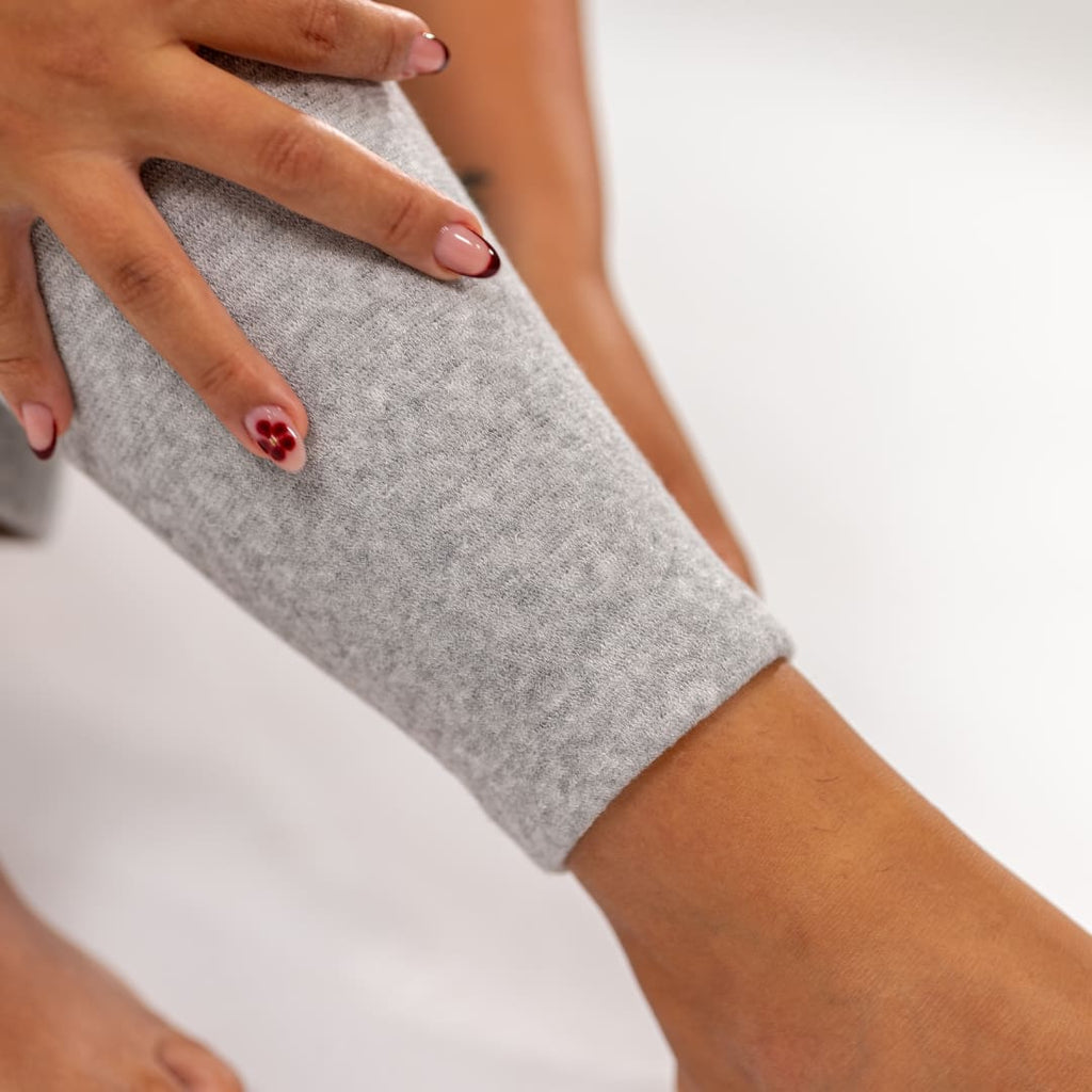 Close-up of gray bamboo compression leg sleeve around the thigh